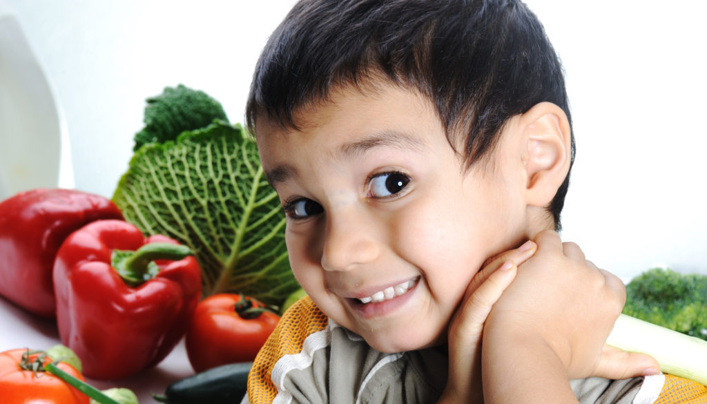 Child and fresh vegetables