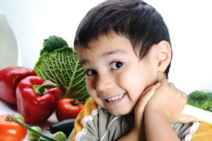 Child and fresh vegetables