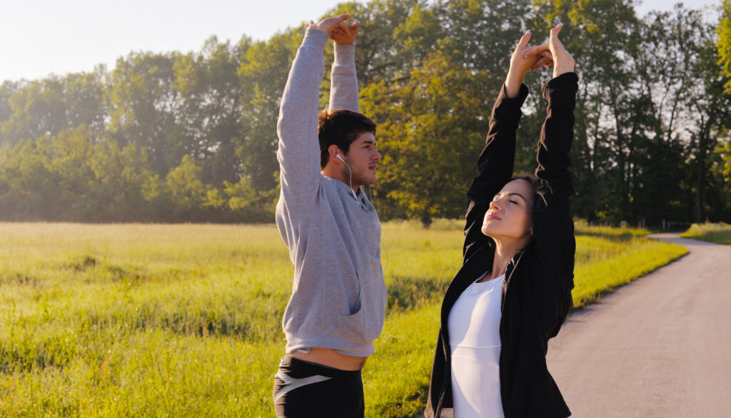 Couple doing stretching exercise  after jogging