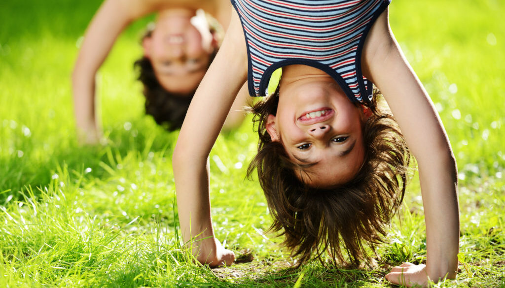 Group of happy children playing outdoors in spring park