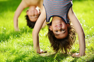 Group of happy children playing outdoors in spring park