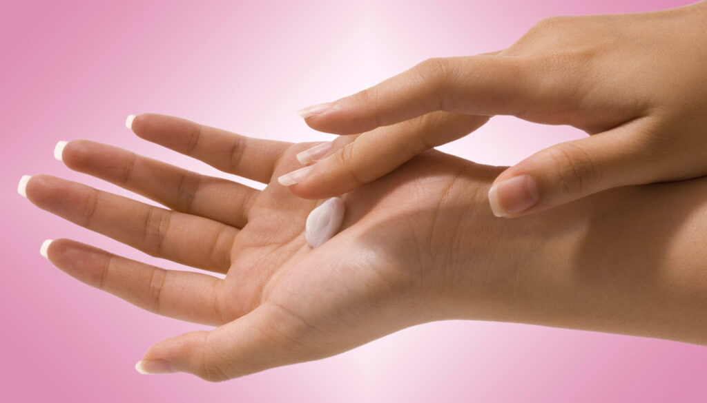 Putting Hand Cream On Her Hands To Moisturize And Clean