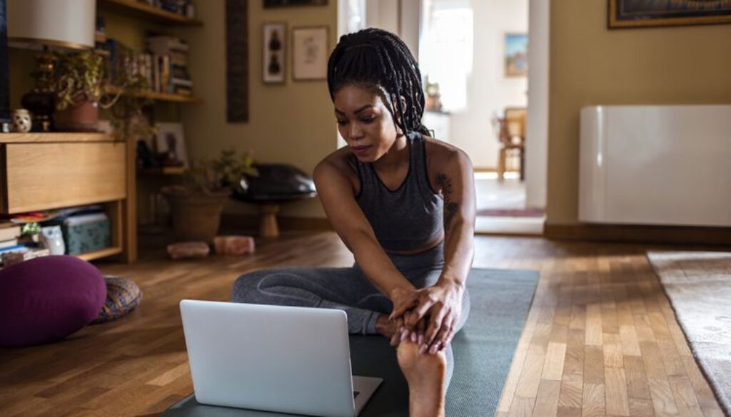 woman-with-laptop-yoga-mat