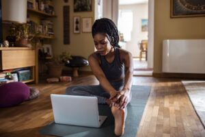 woman-with-laptop-yoga-mat